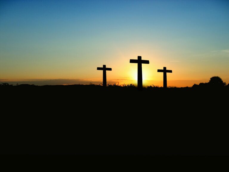 He Is Risen... Now What? Three crosses in front of a sunrise.